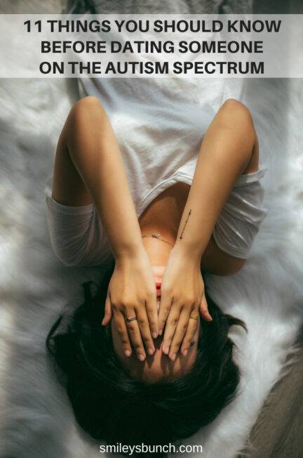 Woman with autism on bed covering her face with hands